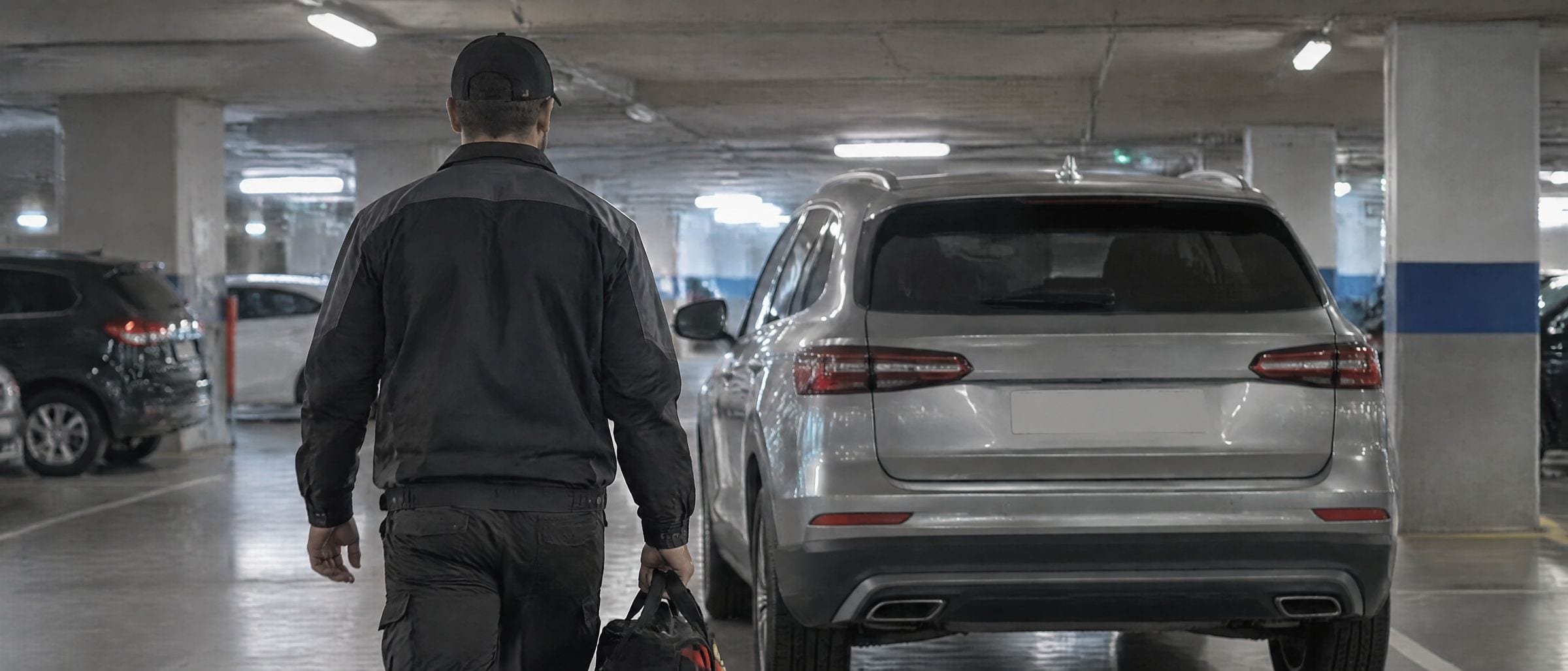 A technician walking through a parking garage